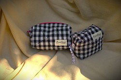 Neceser GRU de Cuadros vichy negro y cierre rosa chicle neón. Pack Neceser Gru inspirado en la ternura y caos de los Minions. Ideal para llevar tus cosas importantes. Tu compra ayuda a transformar la vida de peludines invisibles.